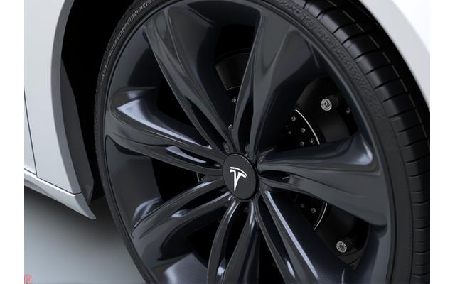 Hover to see After After shot of a Tesla Model Y wheel arch and undercarriage meticulously cleaned and detailed, showing intricate EV components