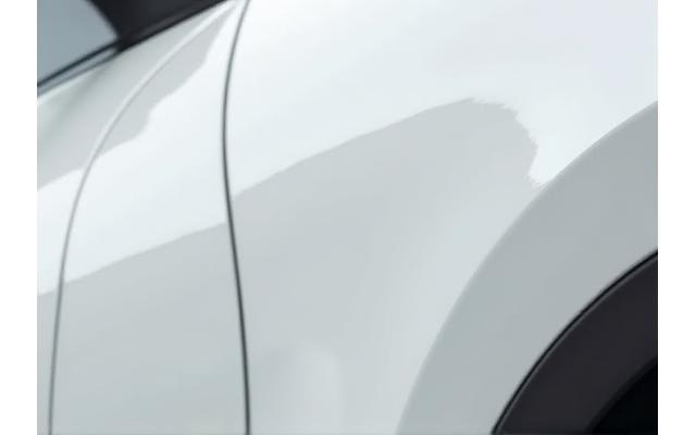 Hover to see After After shot showing the same car's fender, now with an invisible paint protection film applied, looking flawless and protected